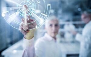 Close up of scientist working on digitally generated image on touch screen